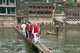 China: Crossing the old wooden bridge across the Tuo River, Fenghuang, Hunan Province